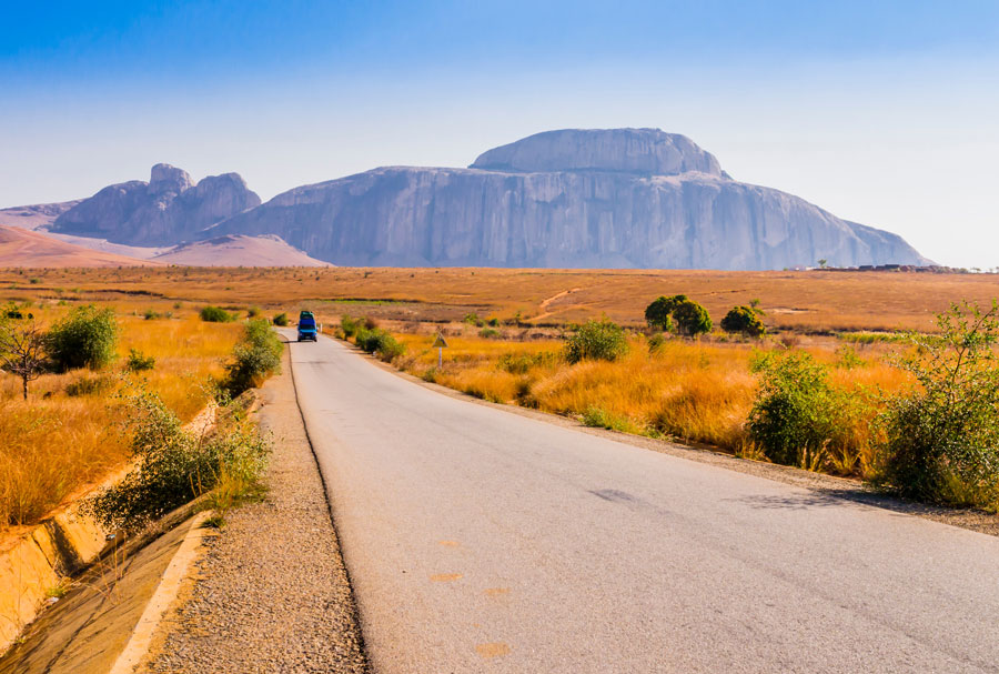 Madagaskar, malerische Aussicht auf die Route Nationale 7 (RN7), mit Kardinalshut im Hintergrund, riesiger Granitberg, der Teil des Andringitra-Massivs ist