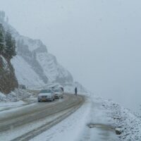 Auto auf einer verschneiten Bergstraße im Winter